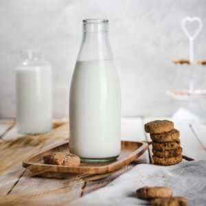 a bottle of milk and some cookies on a table